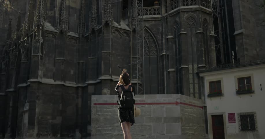 A woman walks past the building ahead