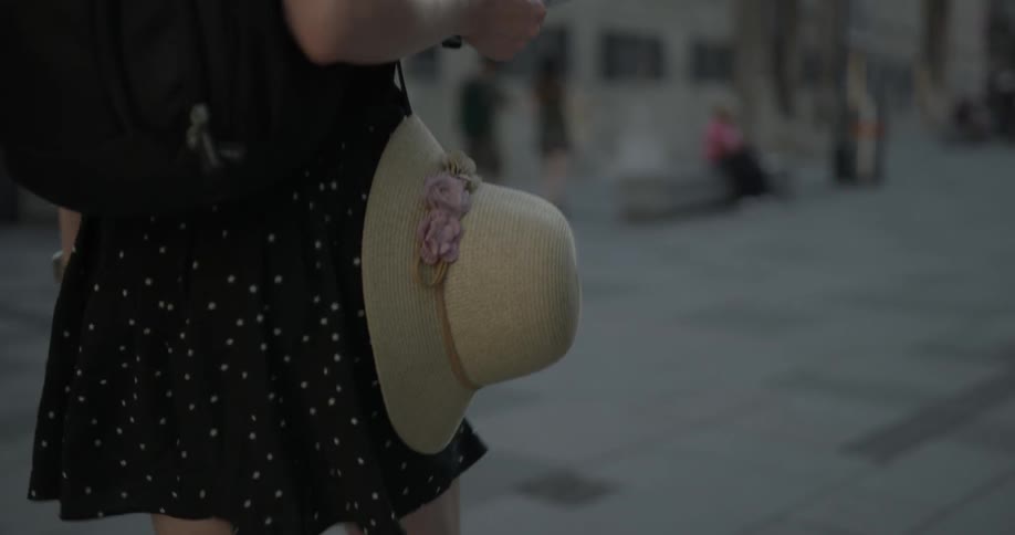 Woman walks along sidewalk