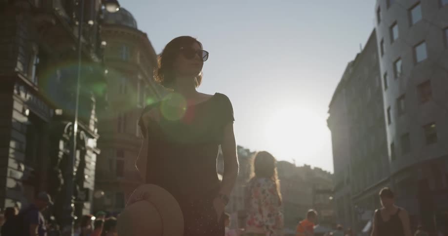 A woman walks down a crowded city street