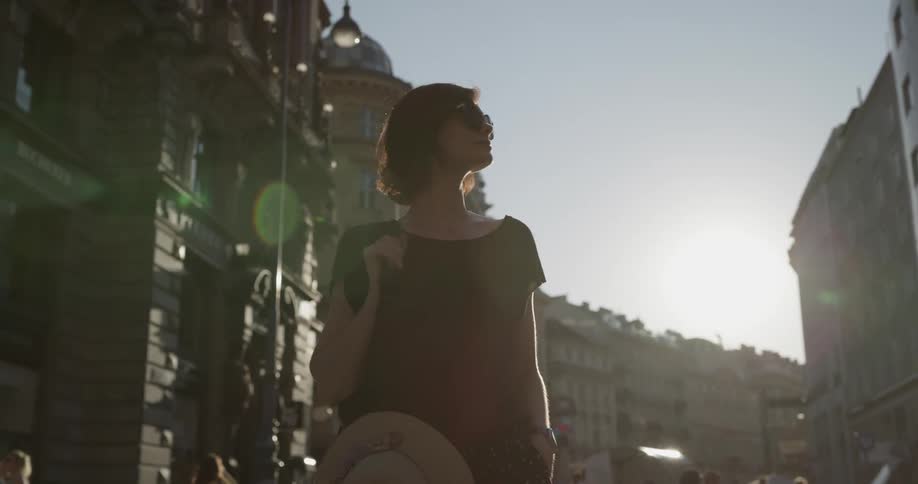 A woman walks along a busy city street