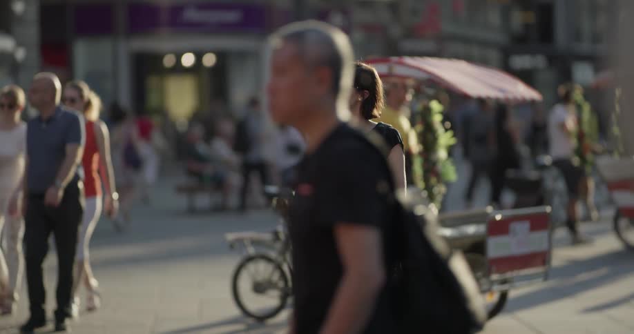 Woman looks at map while standing on sidewalk