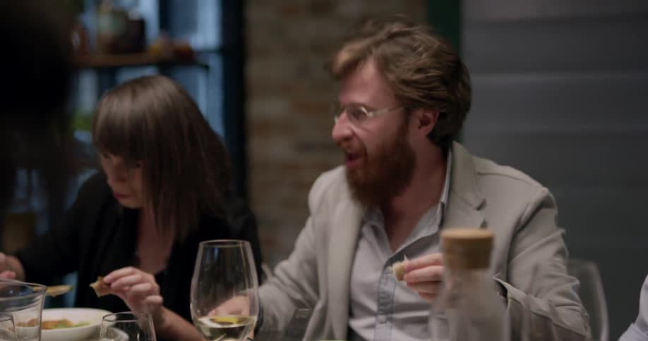 A group of people eating and drinking together