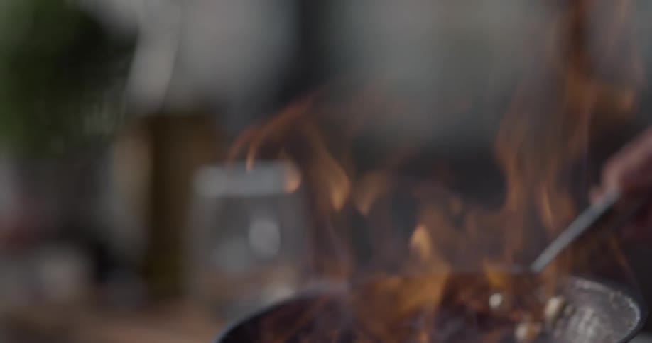 A person pours water into the pan