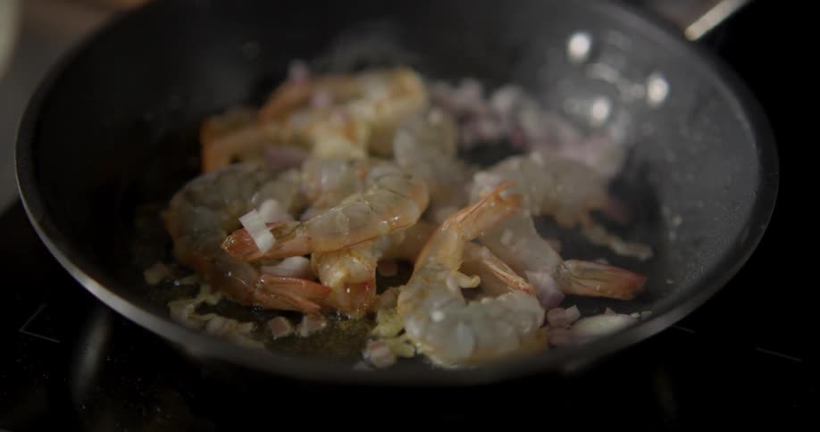 Seasonings shrimp cooking in skillet