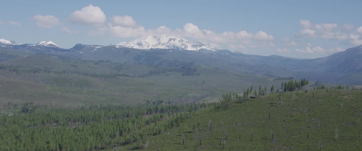 A field in front of a mountainous area