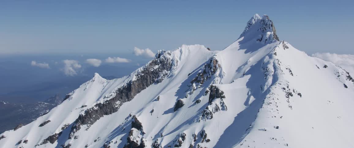Aerial view of peaks of snow covered mountains