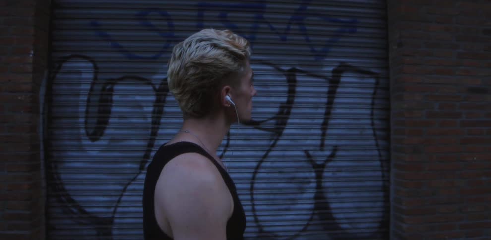 A man is walking outdoors listening to music
