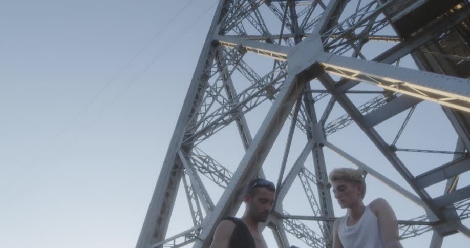 Men sitting on open frame metal tower
