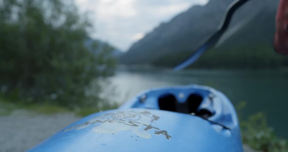 A man is picking up an ore for a kayak