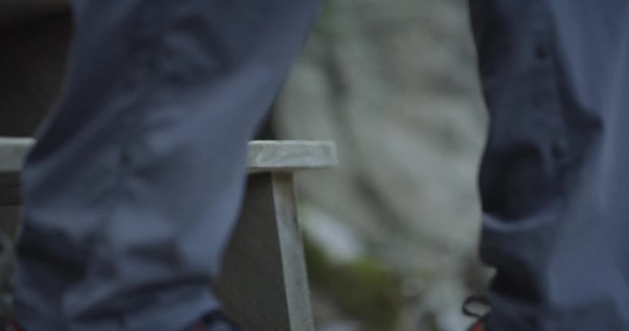 A person walks down outdoor wood steps
