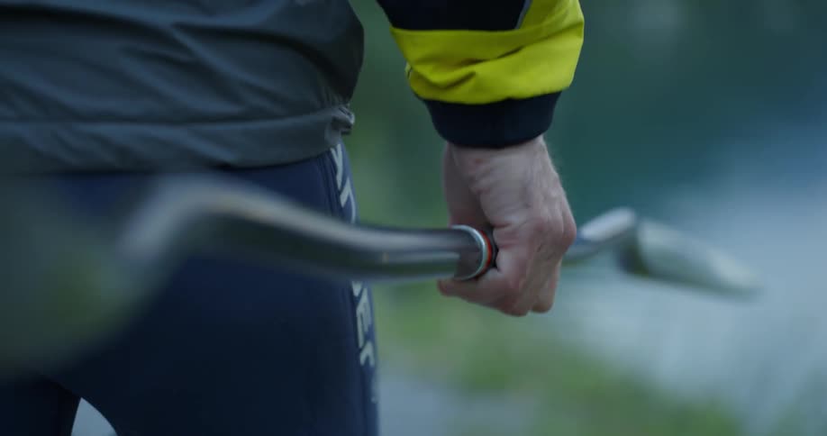 Man carries paddle toward canoe