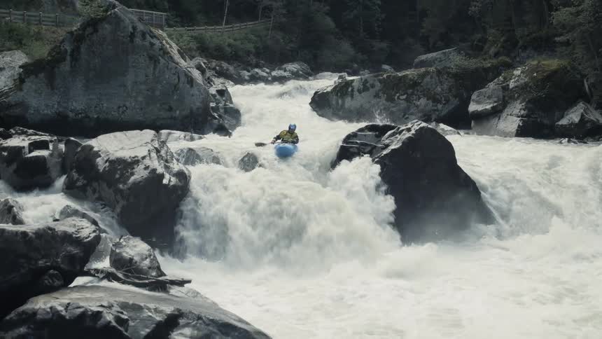 A person is kayaking down a river