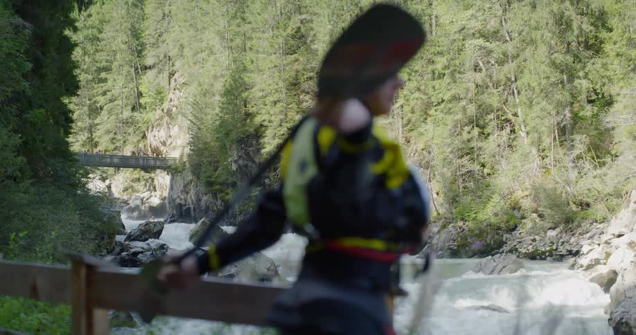 A white man uses an oar to stretch his arms