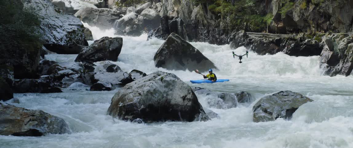 A drone filming white water rafting