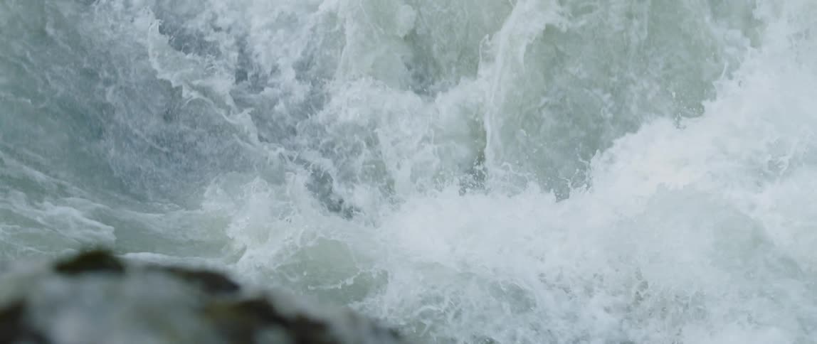 River water crashes over rapids