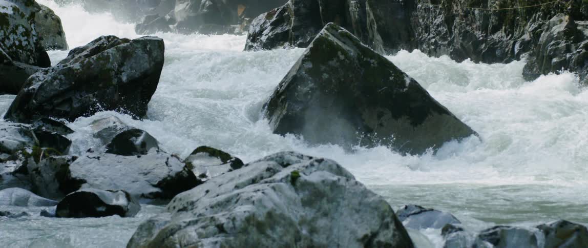 A river cascades down through a canyon