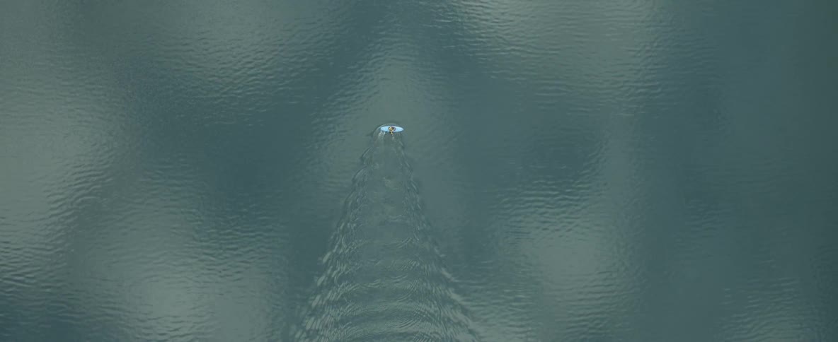 A person in a kayak paddles in a large lake