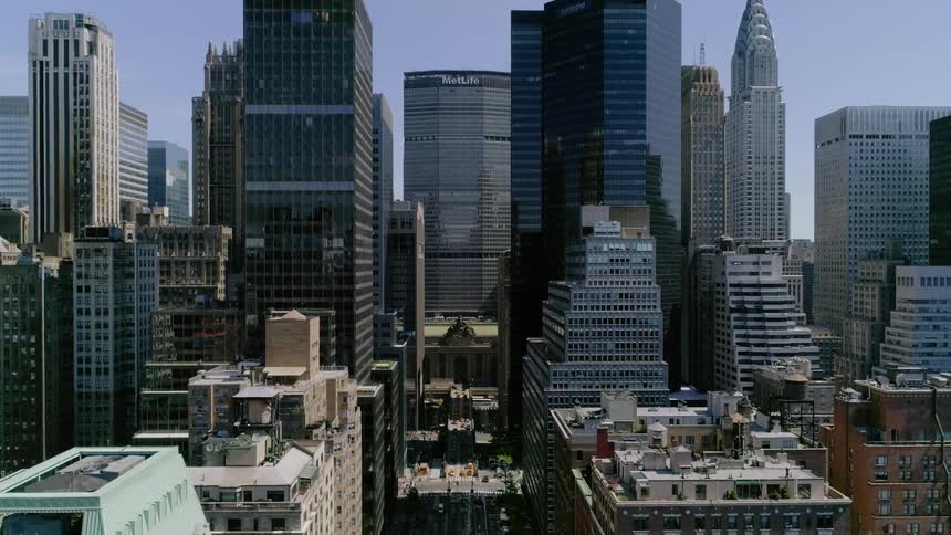Countless skyscrapers including the iconic chrysler building crowd this metropolitan area of new york city on a sunny day