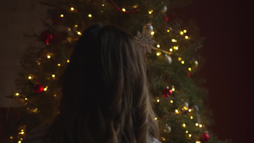 Woman looking at a christmas tree