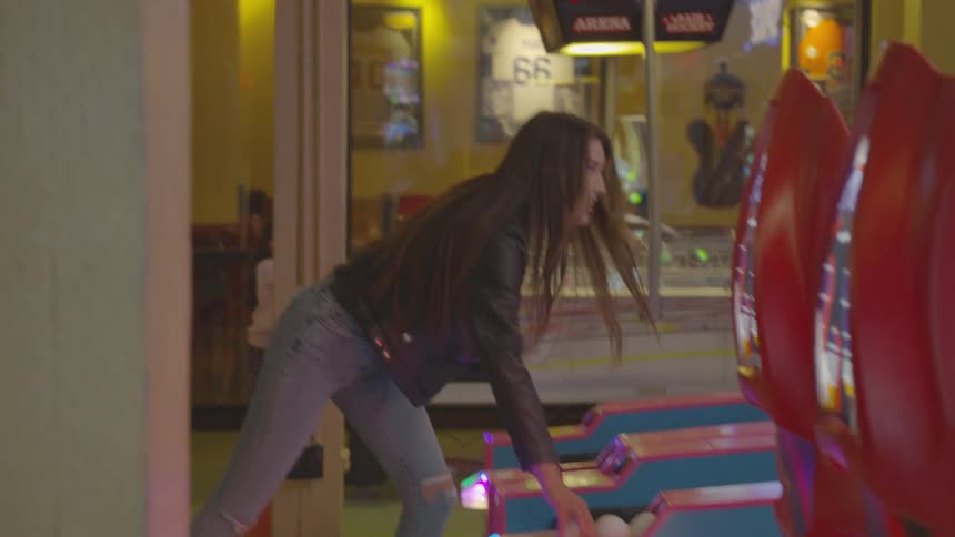 Girl playing an arcade game