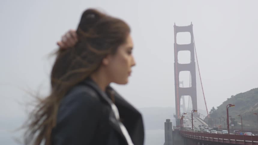 Woman standing next to a bridge