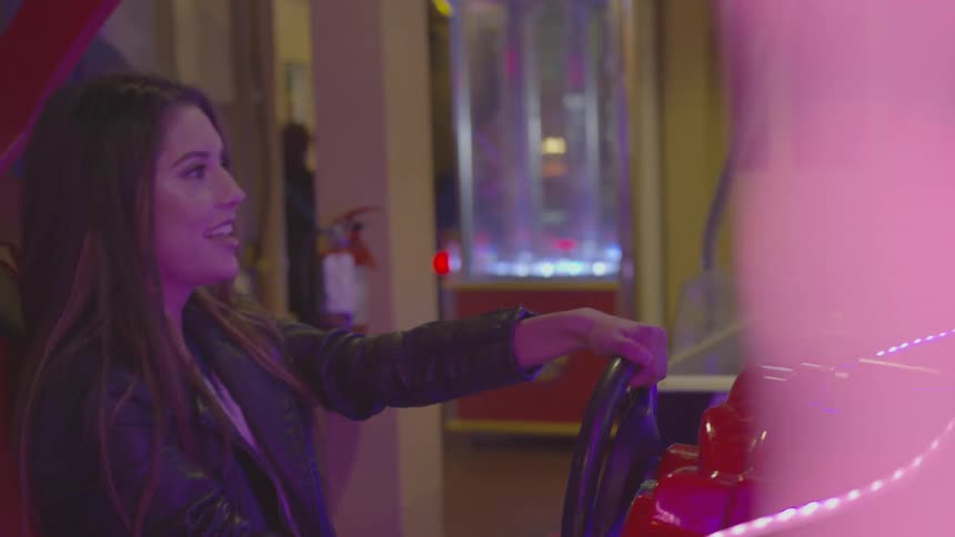 A woman playing at an arcade