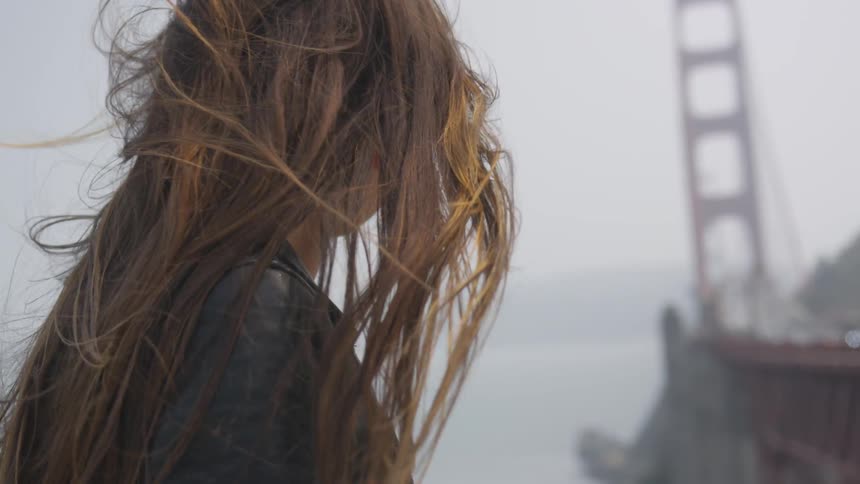 A woman looking out toward a bridge