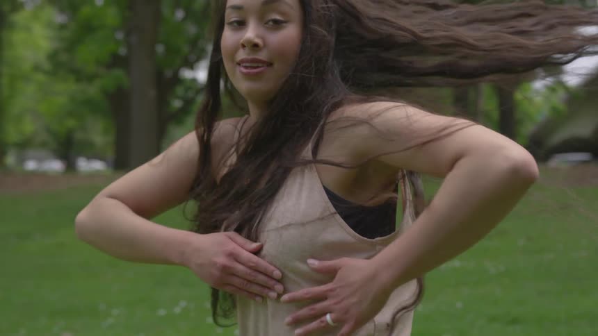 A woman dancing in a park