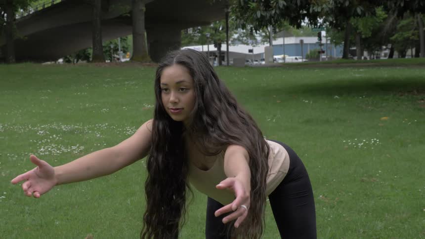 A young woman during yoga in a park