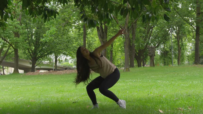 A woman is stretching outdoors