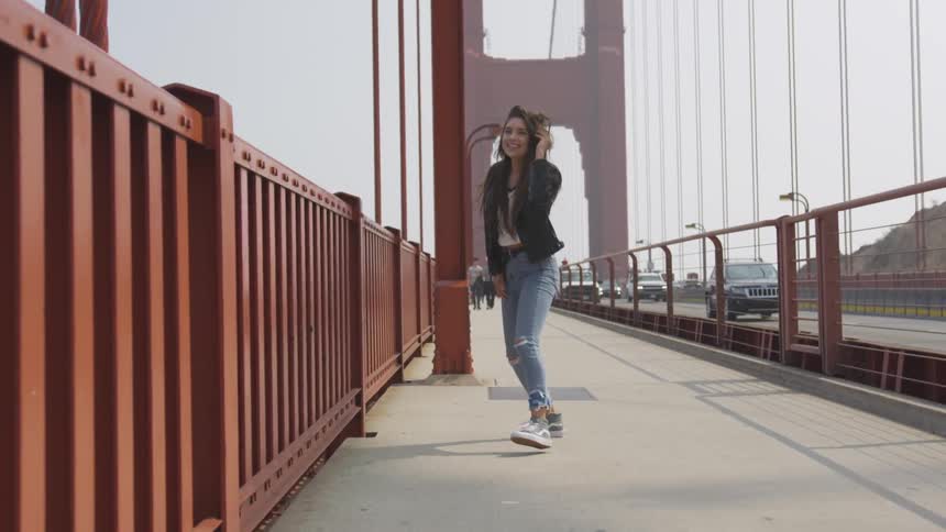 Woman walks on the golden gate bridge in san francisco during daylight