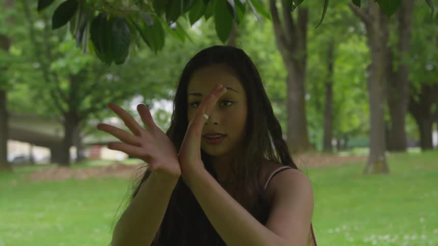 A woman is dancing outdoors