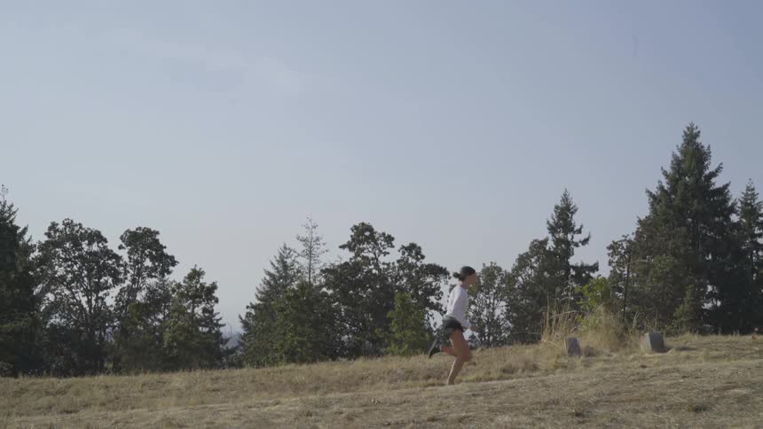 Woman running up a hill