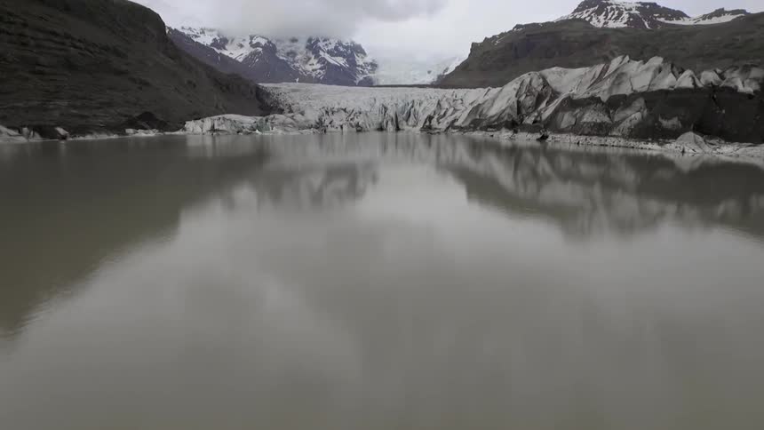 Ice and glaciers on the edge of an arctic mountain pond