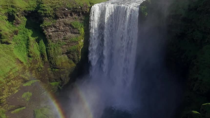 The water rushes down the fall creating rainbows in the spray and mist