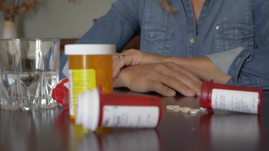 A woman with pills around her