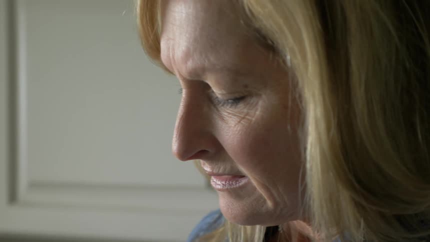 Woman grimaces in pain