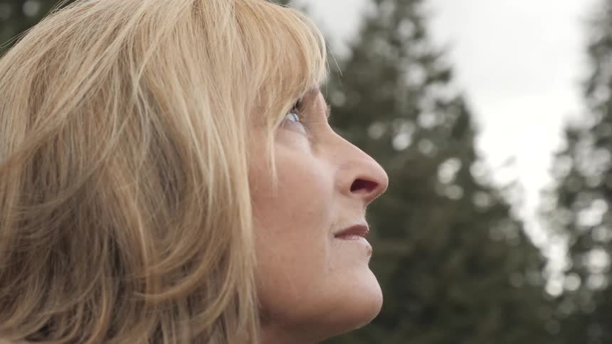 A woman stares at the sky