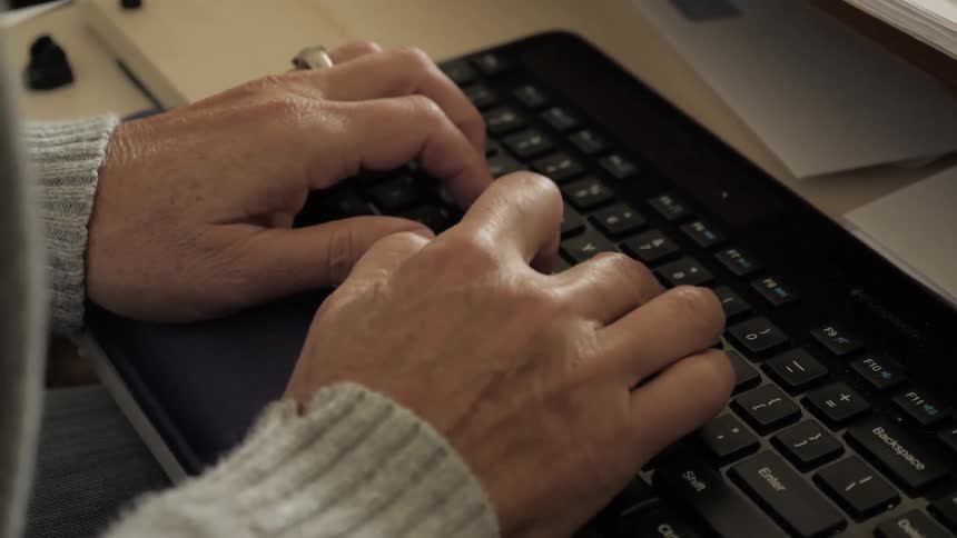 A person types on a keyboard
