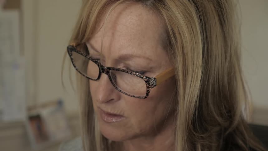 A woman in glasses talks