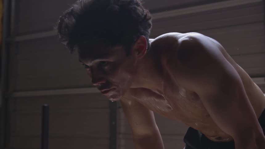 A man sweats in a garage