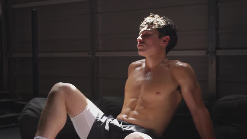 Man sits on floor sweaty and resting