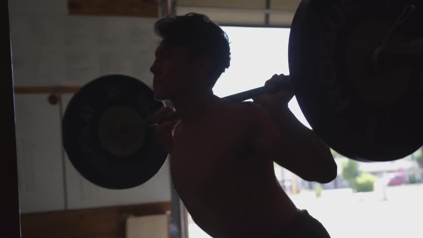 A man is working out in a garage