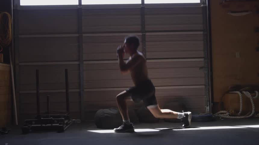 A man jumps and spreads his legs back and forward