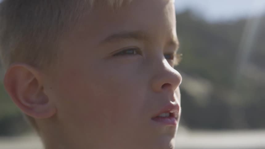 A boy standing outdoors during the day