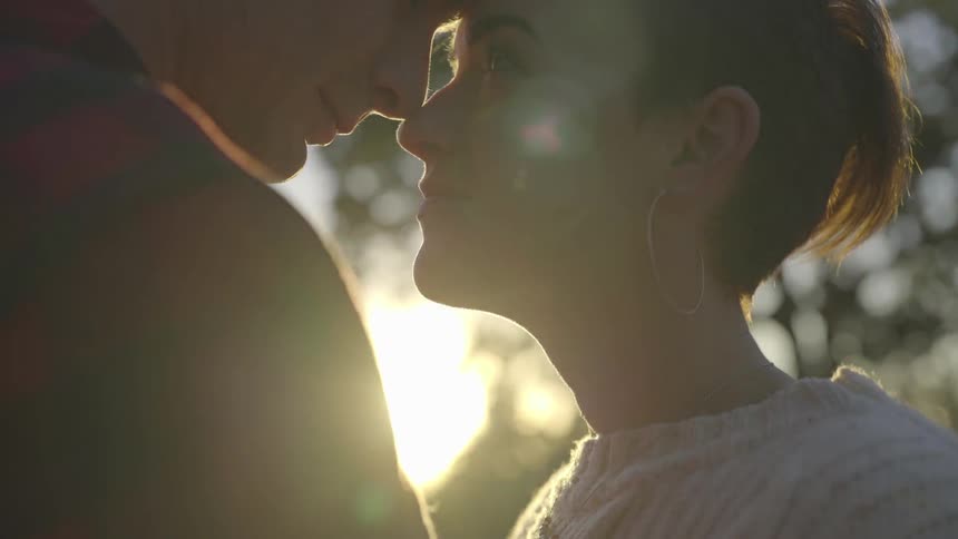 A couple touches foreheads and gazes into each others eyes