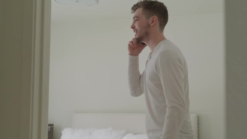 A man angrily talks on the phone gesturing wildly with his hands