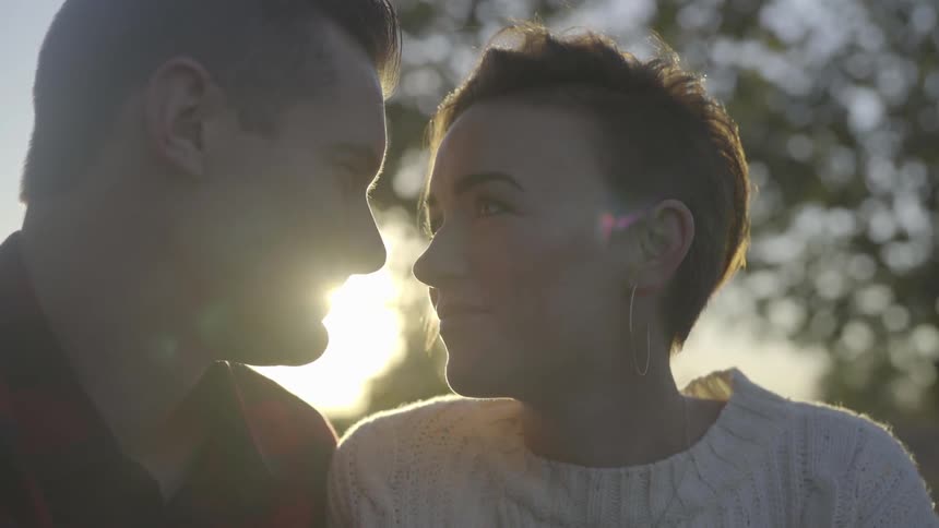 Two people stare into each others eyes smile then touch foreheads