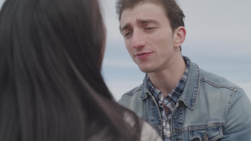 A man tries to console a distraught woman