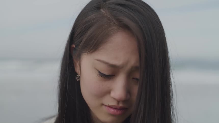 Woman cries and looks up